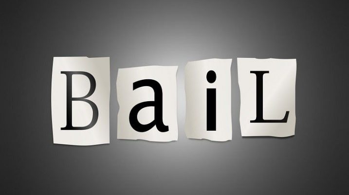 Bail text displayed on torn paper pieces, representing PDQ Bail Bonds services in Colorado.